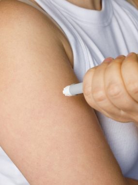 Female,Model,Making,Self,Injection,With,Blue,Injection,Pen,Closeup. Female,Model,Making,Self,Injection,With,Blue,Injection,Pen,Closeup.
