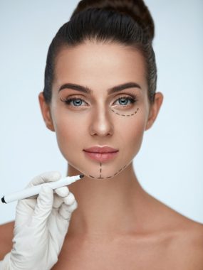 Beauty,Operation.,Closeup,Of,Beautician,Hand,Drawing,Surgical,Lines,On